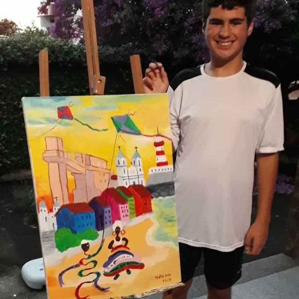10.3.1- Moradores de Macaé e portadores de autismo participam de festival na Flórida, nos Estados Unidos, expondo quadros pintados com o tema os Patuás da Bahia